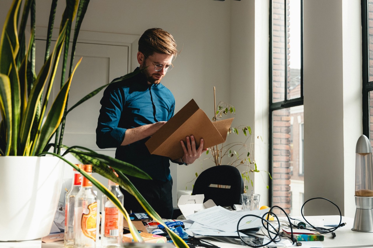 Staff member packing office equipment into a cardboard box