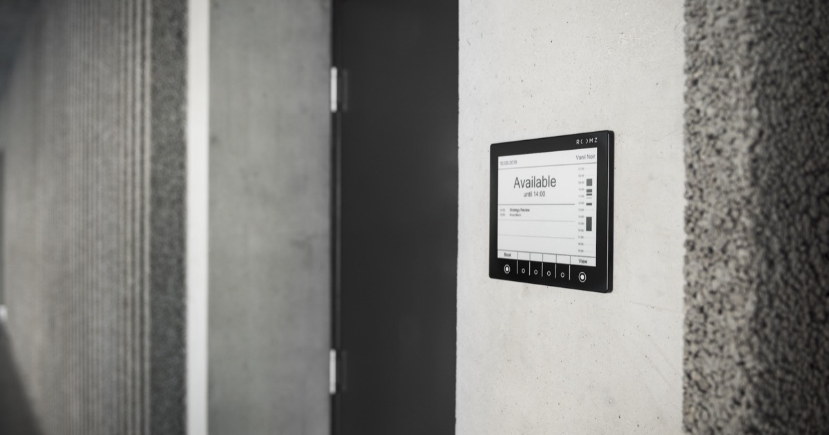 ROOMZ wireless meeting room booking display in a modern office